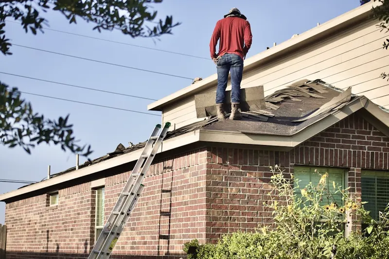Professional roofer working on a residential roof in Kleinville
